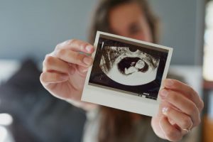 woman holding sonogram after  recieving  ultrasound  prenatal  test.